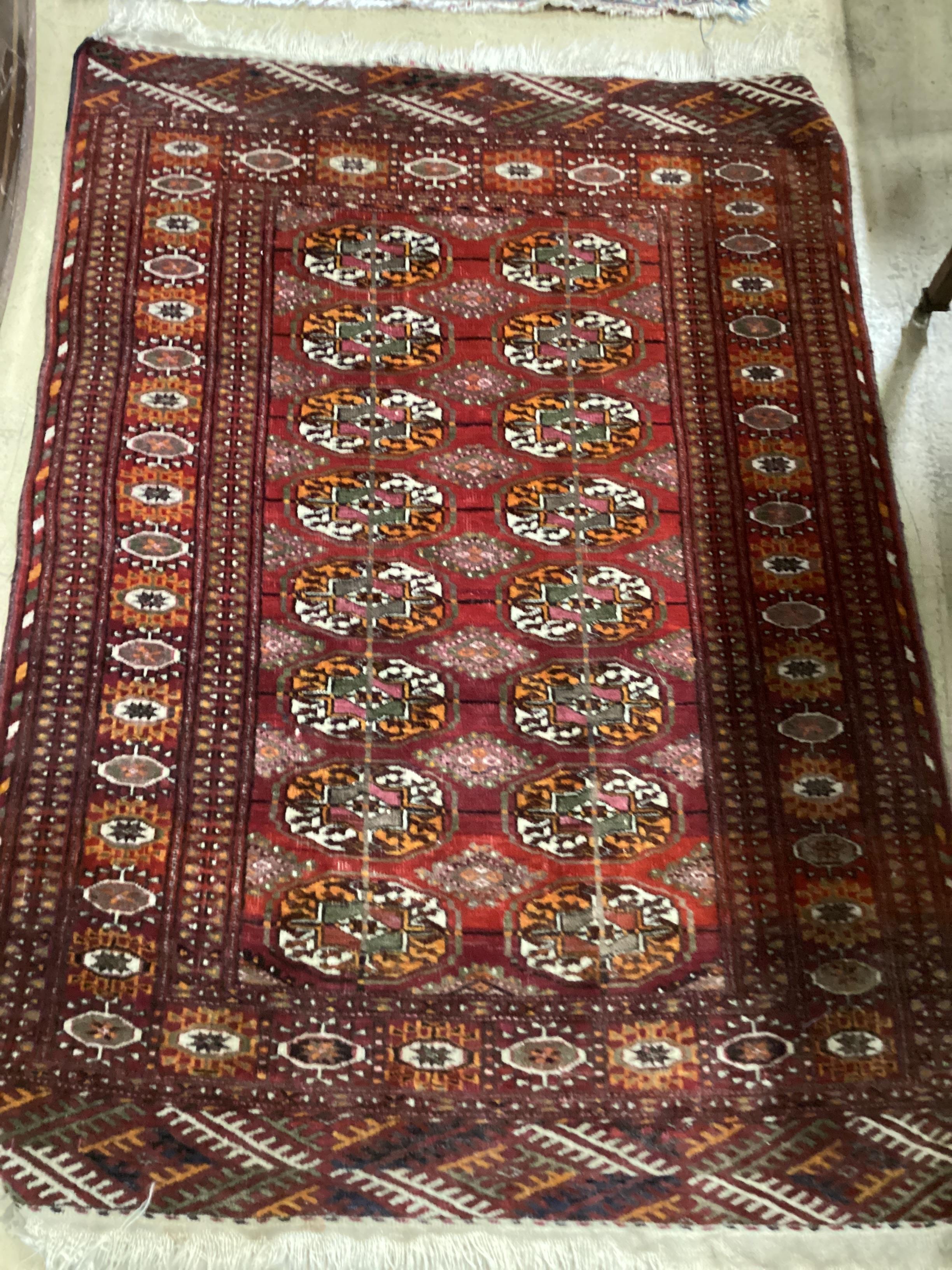 A North West Persian rug and a Bokhara rug, larger 114 x 84cm